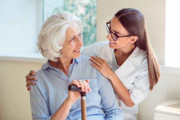Kind one. Smiling senior woman with her home caregiver